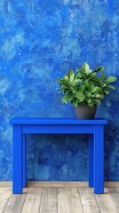 Vibrant blue console table with lush green plant against textured blue wall showcasing the serene Japandi aesthetic indoors