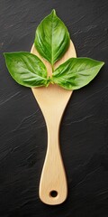 Three Lush Green Basil Leaves on a Wooden Spatula Styled for Elegant Pasta Food Photography on a Dark Background