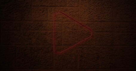 Neon triangle glowing on brick wall, creating modern and artistic ambiance