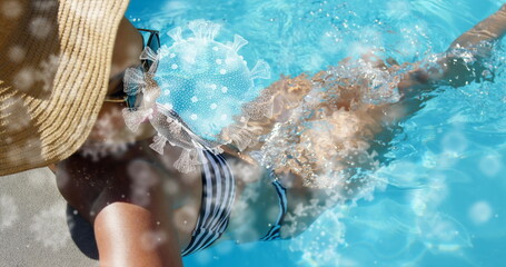 Swimming in pool, woman in swimsuit with virus illustration, emphasizing health awareness
