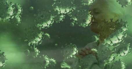 Elderly woman praying with hope, surrounded by virus illustrations, seeking peace