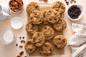 Chocolate chip cookies with pecan nuts, freshly baked cookies on a cooling rack