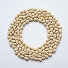Obraz premium White beans in a circle form on a white background. Top view.