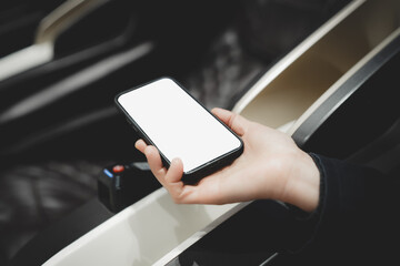 Hand Holding a Smartphone in a Movie Theater Seat
