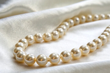 Close-Up of a String of Pearls with Delicate Shine on White Background