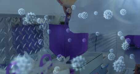 Scientist in lab coat conducting research with virus graphics overlay