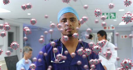 Healthcare worker in hospital surrounded by virus illustrations, showing resilience