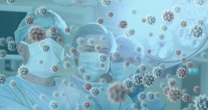 Image of 3d covid 19 cells floating over doctors wearing face masks