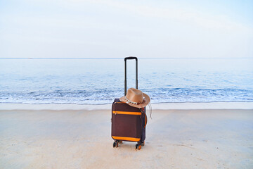 Suitcase on the seashore ready to traveling time. Vacations concept, beach holidays and recreation at sea