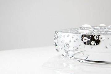 gleaming perfectly polished chrome faucet with sparkling water droplets on pristine white background spotless allure