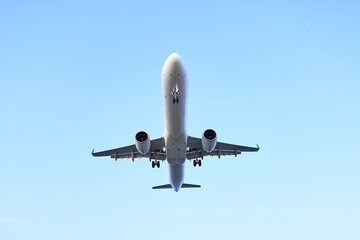Large passenger plane flying in the blue sky