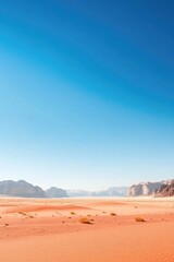 Fototapeta premium vast desert landscape stretches under clear blue sky dotted with resilient desert plants that thrive against all odds