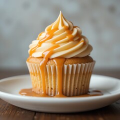A delicious cupcake topped with creamy frosting and drizzled with sweet caramel sauce, perfect for dessert lovers.