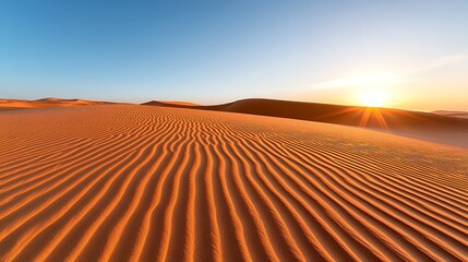 Naklejka premium Desert Sand Dunes at Sunset with Bright Sun and Clear Blue Sky Landscape