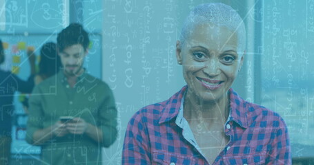 Image of mathematical formulae over woman using tablet