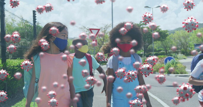 Image of floating covid 19 cells and schoolchildren wearing face masks walking to school - Powered by Adobe