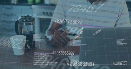 Image of numbers changing and financial data processing over man paying online using laptop