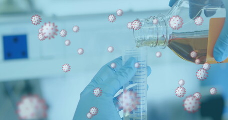 Image of floating covid cells and hands of scientist working in lab