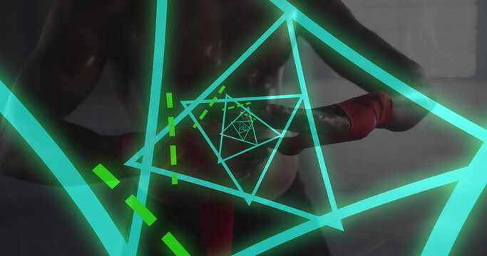 Image of green glowing neon triangles over man wrapping hands before boxing practice - Powered by Adobe