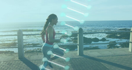 Image of dna strain spinning over woman jogging on promenade by the sea