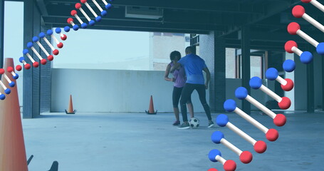 Image of two dna strains spinning over man and woman playing football