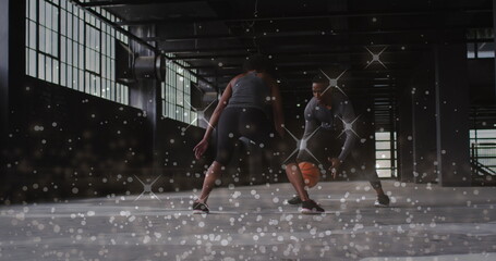 Image of floating shiny dots over man and woman playing basketball