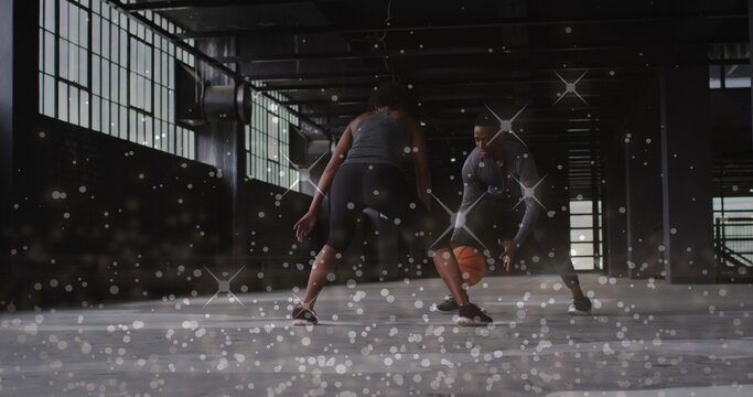 Image of floating shiny dots over man and woman playing basketball
