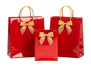 Fototapeta premium Three red gift bags with gold bows. Perfect for holidays or special occasions.