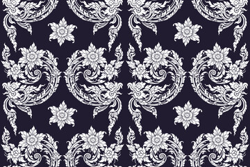 Seamless bold white colored traditional Thai art floral pattern in damask style motifs suitable for wallpaper, textile, tile, cloth and fabric design isolated over blue colored background.