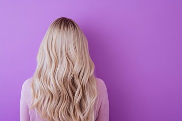 Fototapeta premium Woman with Blonde Wavy Hair Against a Purple Background Studio Shot