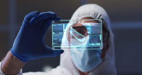 Image of scientist holding interactive screen with medical data processing