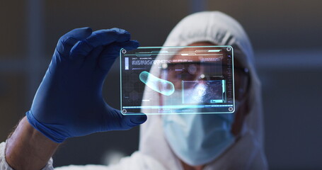 Image of scientist holding interactive screen with medical data processing