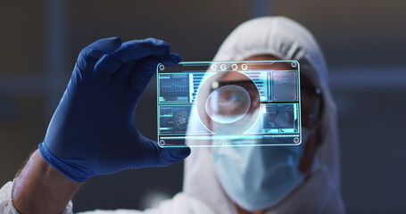 Image of male scientist holding interactive screen with medical data processing