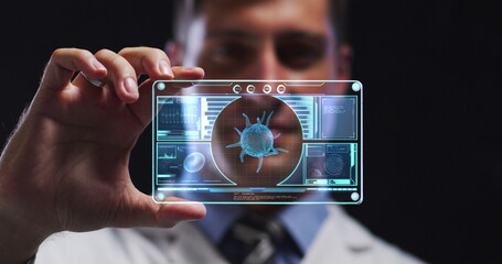 Image of male scientist holding digital screen with covid 19 cell