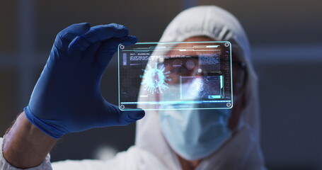 Image of male scientist holding digital screen with covid 19 cell
