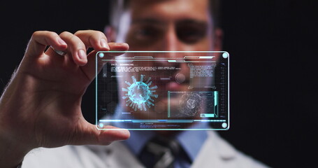 Image of male scientist holding digital screen with covid 19 cell