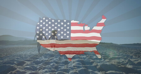 American flag waving over us map against couple holding hands running on the beach