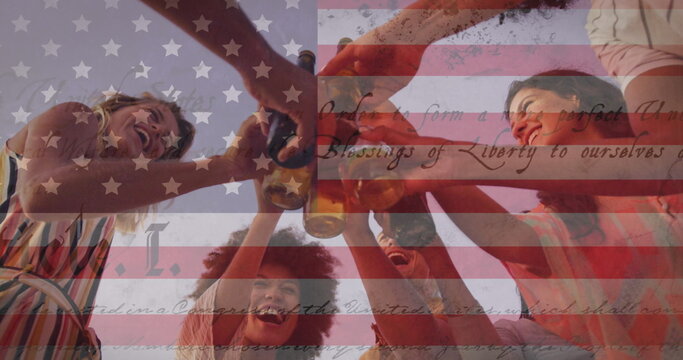 Constitution text over american flag against group of friends toasting drinks on the beach - Powered by Adobe