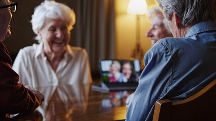Cheerful elderly woman enjoying virtual connection with family on a tablet, highlighting the joy of technology and relationships in a warm, cozy indoor setting.