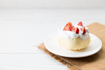 Crepe cake topped with fresh cream and strawberries.