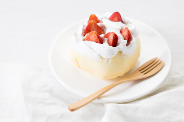 Crepe cake topped with fresh cream and strawberries.