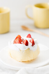 Crepe cake topped with fresh cream and strawberries.
