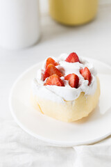 Crepe cake topped with fresh cream and strawberries.