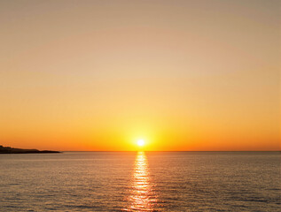 Scenic sunset over ocean horizon with golden light reflecting on water, creating a serene and peaceful atmosphere. Beautiful natural landscape background. Ai generative