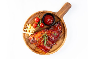 Delicious barbecued ribs seasoned with a spicy basting sauce herbs on wooden chopping board