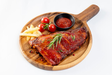 Delicious barbecued ribs seasoned with a spicy basting sauce herbs on wooden chopping board