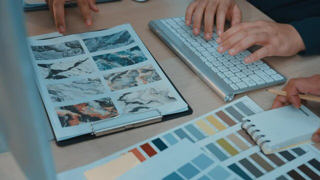 A designer workspace featuring hands analyzing color samples and mood boards. The scene captures the essence of creativity and organization in a modern design studio. SACTR