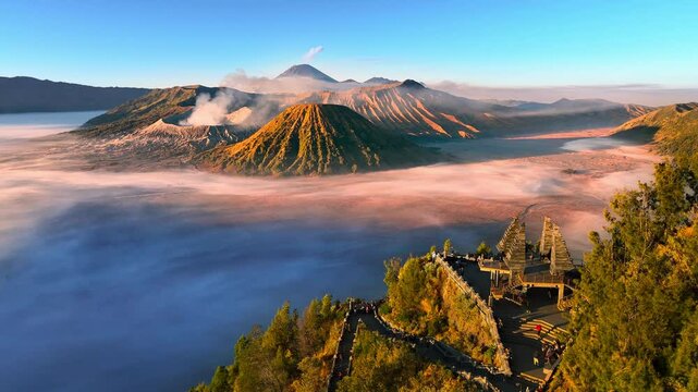 Aerial view flying to mount Bromo at sunrise, active volcano above sea of clouds, Java, Indonesia 
