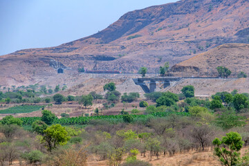 Saffron coloured Vande Bharat Express near Pune India. This is a tri-weekly train between Pune and Kolhapur and also a tri-weekly train between Pune and Hubballi.