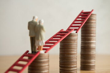 Old senior couple person walking on growth stack coins graph chart with red ladder. Financial...